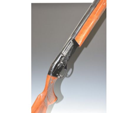 Remington model 1100 12 bore 3-shot semi-automatic shotgun with ornately carved and chequered semi-pistol grip and forend, en