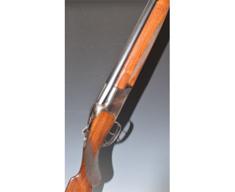 Miroku 12 bore over and under shotgun with border engraved lock, chequered semi-pistol grip and forend, vacant cartouche to t