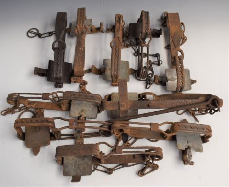 Ten vintage animal traps including some named including one stamped 'Collins JC Genuine', largest 31x15cm.&nbsp;