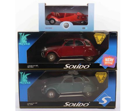 Three 1/18 scale boxed diecast model cars, including two Solido prestige Citroen 2cv, one red, one blue, Oxford diecast model