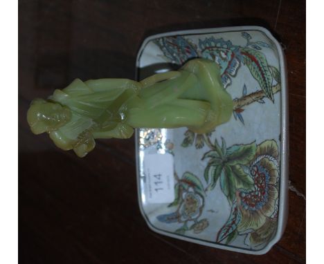 An Oriental jade statue of a monk with an Oriental tray