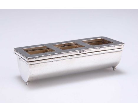 A VICTORIAN SILVER STAMP BOX by Lawrence Emanuel, Birmingham 1898, the demilune trough with two divisions, the sprung hinged 