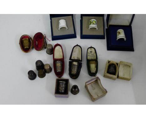 A collection of 19th century and later thimbles to include silver examples, three Royal Worcester bone china examples and a b