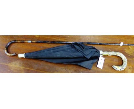 A vintage silver mounted walking cane together with an umbrella with faux ivory handle (2) 