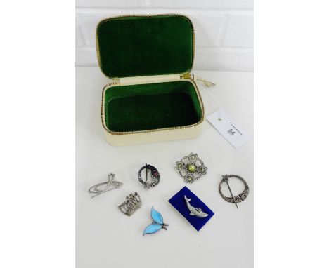 A Scottish silver viking boat brooch, Danish silver and enamel brooch and miscellaneous white metal costume brooches, contain