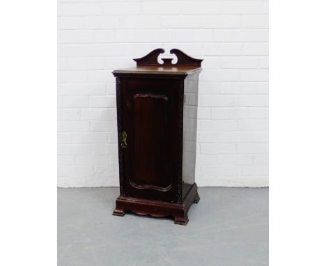 A mahogany bedside cupboard, the square top with a swan neck ledgeback over a panelled door, on bracket support, 88 x 40cm 