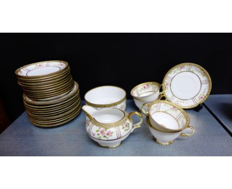 A Noritake floral decorated porcelain tea set with gilt highlights comprising twelve cups, twelve saucers, twelve side plates