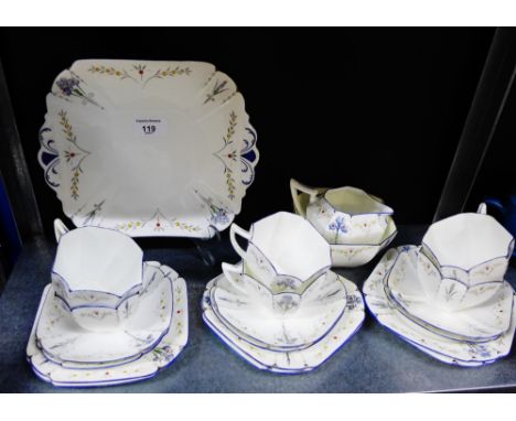 A Shelley porcelain white glazed tea set of octagonal form painted with irises and black dot pattern, comprising six cups, si