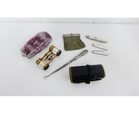 A mixed lot to include a white metal mounted chain purse, a leather pouch containing military buttons, a pair of mother-of-pe