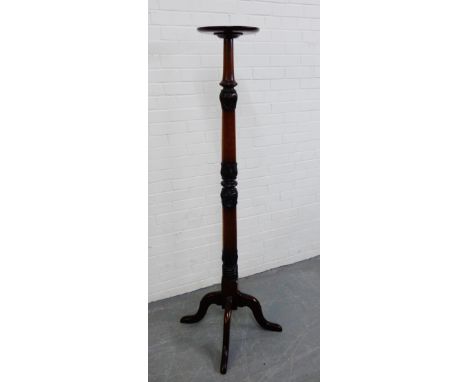 A mahogany torchere, on carved tripod supports, 180cm