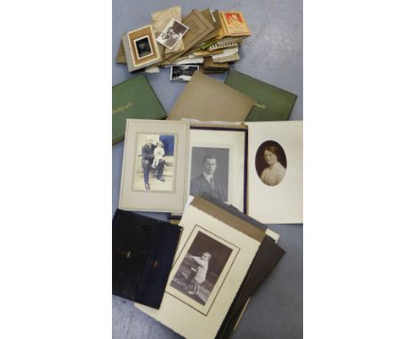 A carton containing a quantity of vintage black and white photographs (a lot)