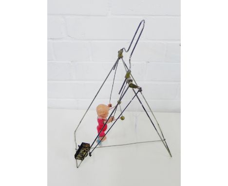 A vintage Japanese celluloid wind up acrobat toy, 39cm high 