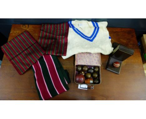 A mixed lot to include a cricket ball, a pair of cricket ball mounted book ends, two scarves and a cricket jumper, a small le