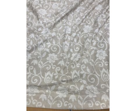 A pair of linen type foliate design by Jonelle in beige and cream lined curtains with taped pencil pleat headings approx. 220
