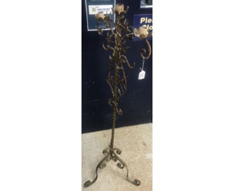 A circa 1900 French painted and gilded floor standing three branch candle light holder with scrolling foliate and floral deco