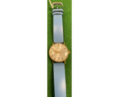 A gold cased Swiss gentleman's wristwatch for Garrard, the silvered dial with gold batons and date aperture inscribed "Garrar