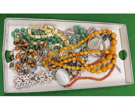A box of various costume jewellery including an amber bead necklace, coral bead necklace, jade coloured glass bead necklace, 