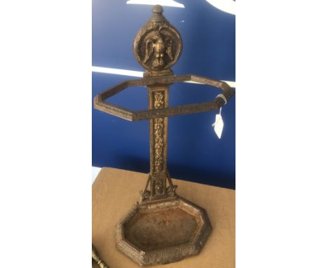 A late Victorian brassed cast iron stick stand in the Aesthetic taste, together with three various fire irons