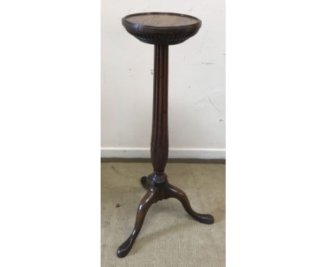 A 19th Century mahogany urn or aspidistra stand, the dished and carved circular top on a lotus leaf carved and reeded column 