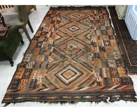 A Kelim carpet, the central panel set with four repeating diamond medallions in orange, brown, blue and red etc within a step