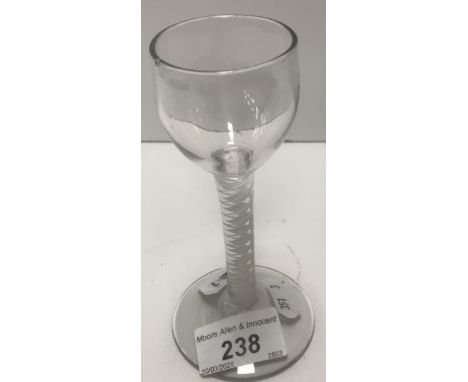 An 18th Century wine glass, the plain bowl on an enamel twist stem to circular foot, 13.5 cm high