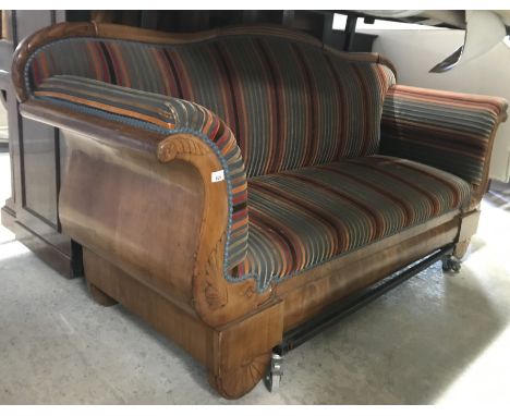 A 19th Century Biedermeier style walnut framed scroll arm sofa with stylised dolphin decoration, on reeded demi-lune or sunbu
