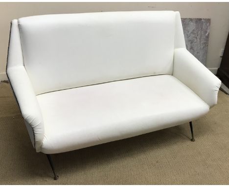 A mid 20th Century white leather and studded upholstered two seat sofa attributed to Gio Ponti, on slender ebonised and brass