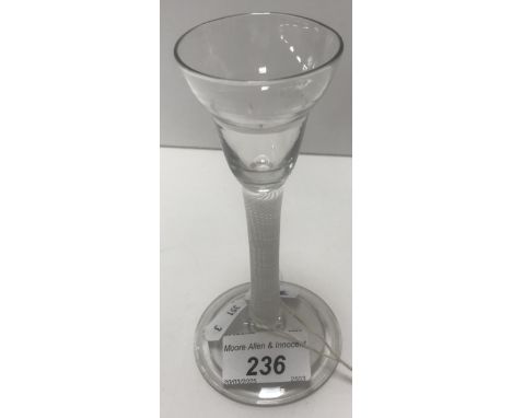 An 18th Century wine glass with ogee bowl on an enamel twist stem to circular folded foot, 14.8 cm high