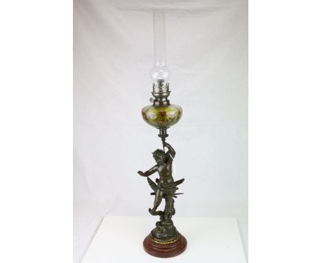 Late 19th century Bronzed Spelter Oil Lamp, the column in the form of a Cherub holding the floral painted glass well, raised 