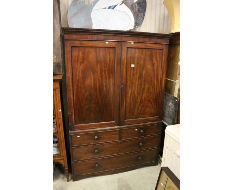 George III Mahogany Linen Press, the two panel doors opening to reveal five linen slides, over Two Short and Two Long Drawers