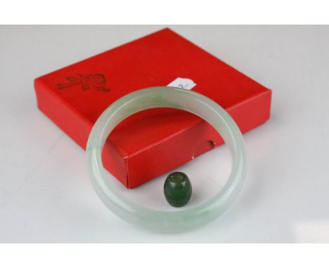 Pale jade bangle, width approximately 13mm together with a jade type polished bead, length approximately 14mm (2)