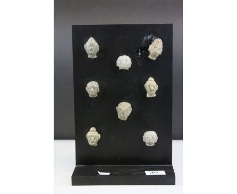 Eight Burmese Ceramic Fertility Heads mounted on a Display Board, each head approximately 4cms high
