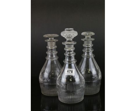 Set of Three George III Glass Decanters with faceted panels and a wheel cut horizontal panel, triple ring neck, lacking stopp