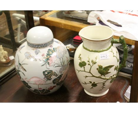 A late 19th century ceramic jug with embossed bird on a branch decoration together  with a ginger jar with lid.
