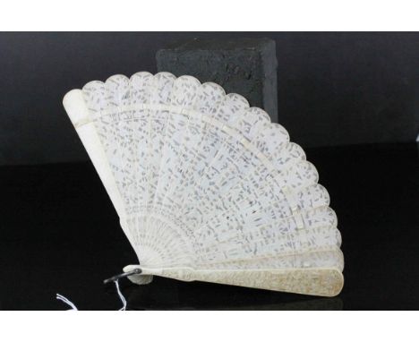 19th century Chinese carved  ivory fan, each pierced panel depicting pagoda, prunus trees and elders in landscapes, 21 sectio