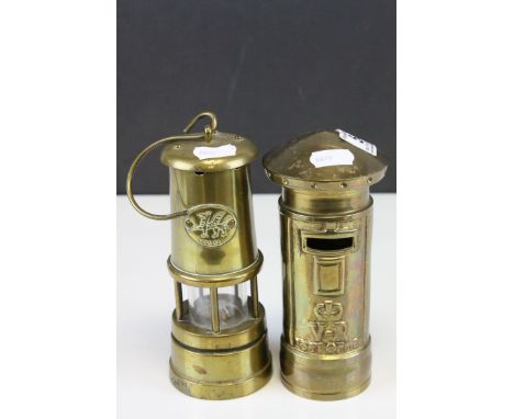  A novelty moneybox in the form of a postbox and a brass musical miners lamp.