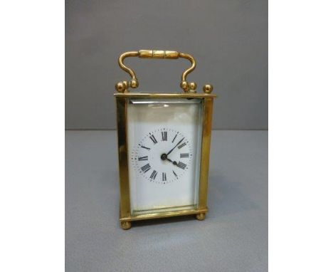 A brass carriage clock with French movement.