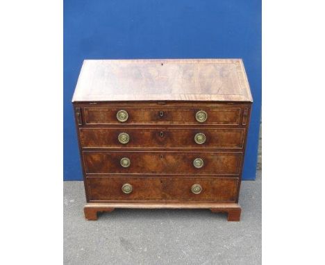 A George III mahogany bureau of excellent colour, the well figured, paterae inlaid and cross banded fall enclosing a boxwood 