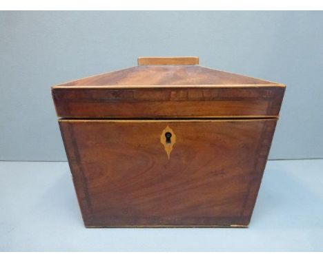 A Regency mahogany and boxwood strung two section tea caddy of sarcophagus form with brass lion ring handles.