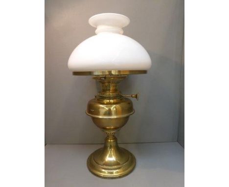 A Youngs brass oil lamp and shade. 