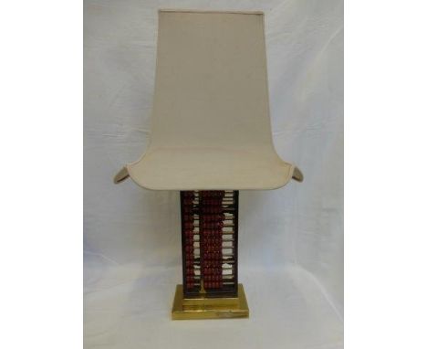 An unusual Chinese style table lamp of abacus form, with pagoda shaped shade, raised upon a steeped brass base. 