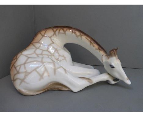 A USSR ceramic model of a large recumbent giraffe.