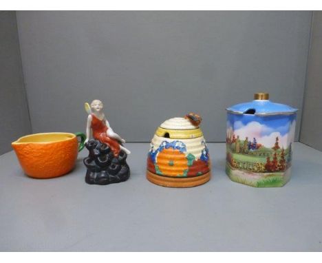 A Clarice Cliff 'Gay Day' honey pot, a Carltonware orange milk jug etc. 