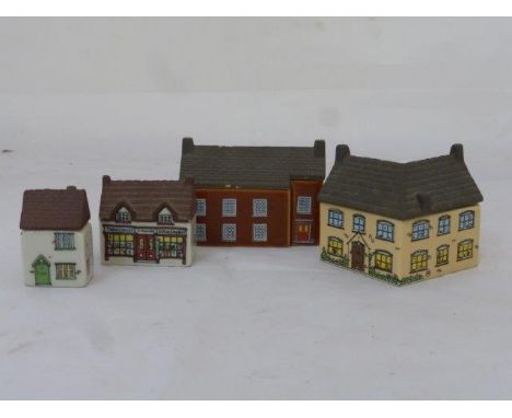 A collection of four Wade Whimsie ceramic houses. 