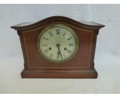 An Edwardian mahogany mantle clock with circular dial and inlaid decoration. 