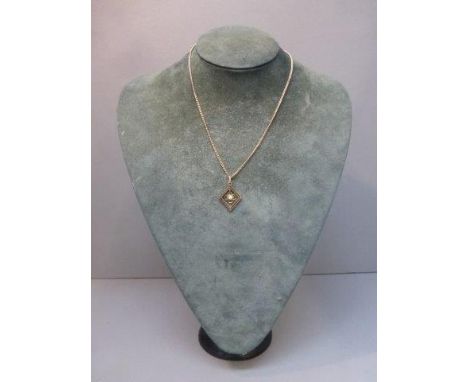 An Edwardian 9ct gold pendant necklace set with an opal. 