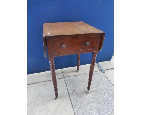 A 19th Century mahogany drop flap lamp/occasional table with single drawer raised upon turned supports to castors. 