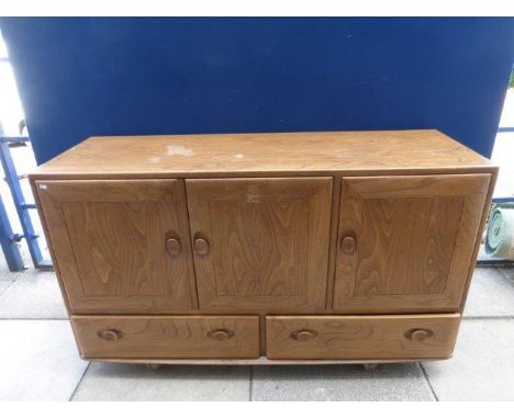 A light elm Ercol sideboard. 