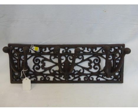 A cast metal triple tool/coat hanger set. 