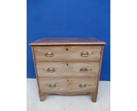 A Georgian inlaid mahogany chest of three drawers, raised on bracket supports. 